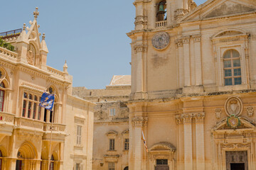 Naklejka premium Historic architecture of Metropolitan Roman Catholic Cathedral of Saint Paul in main town square of Mdina old town on a sunny day, the silent city, ancient capital of Malta, Europe.