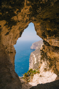 Scenic viewpoint over Dingli Cliffs, Malta. Natural stone arch and sea caves. Arch window in rock.