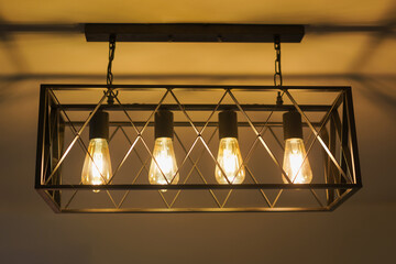 Modern beautiful brass metal ceiling lamp light bulb tungsten vintage style interior in living room...