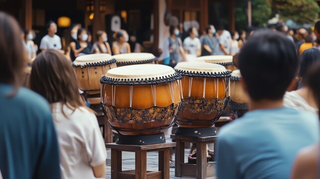 Audience watches traditional drumming performance in a lively outdoor setting.