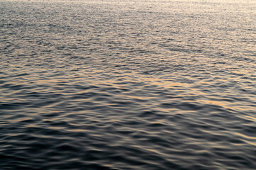 Water sea sunset. Sun reflection ocean waves. Nature golden abstract texture surface.