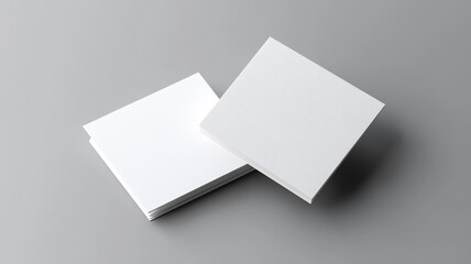 two white  cards floating on a grey background. Mockup for design.