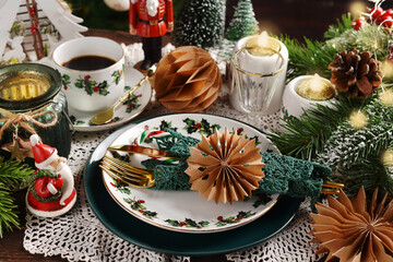 Christmas table setting with white and green color decors and tableware in retro style