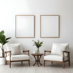 Two white leather armchairs, a small round wooden table between them, against a white wall with two empty picture frames.