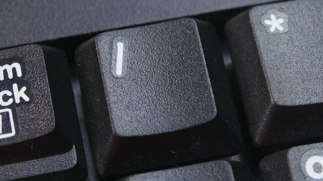 Slash, solidus, virgule, upward slash, Symbol Key on Desktop Keyboard Pressed by Finger Hand Multiple Times - Close Up Macro Shot