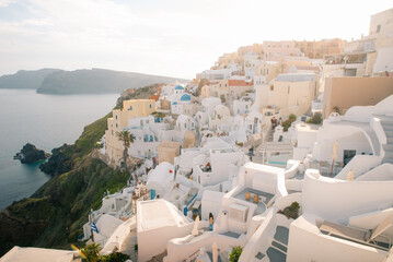 Fototapeta premium Fira town by the sea on mountain coast of Santorini island in Greece - 2 may 2024