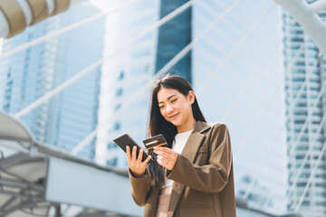 Happy smile young woman using creadit card and digital tablet for shopping online payment
