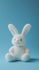 Obraz premium Cute White Bunny Plush Toy on Blue Background