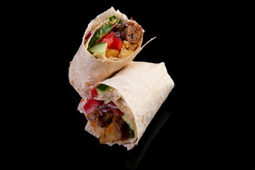 Delicious doner kebab on a black background. Shawarma.