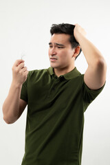 Concerned man inspecting a hair strand