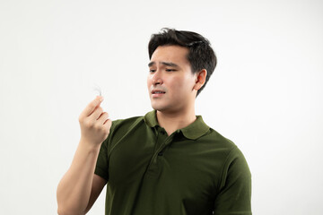 Concerned man inspecting a hair strand, highlighting hair loss or thinning hair issues