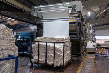 Fabric batching process machine industrial plant line in a textile factory.