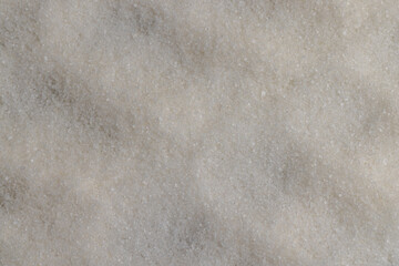 close-up of white granulated sugar on black slate