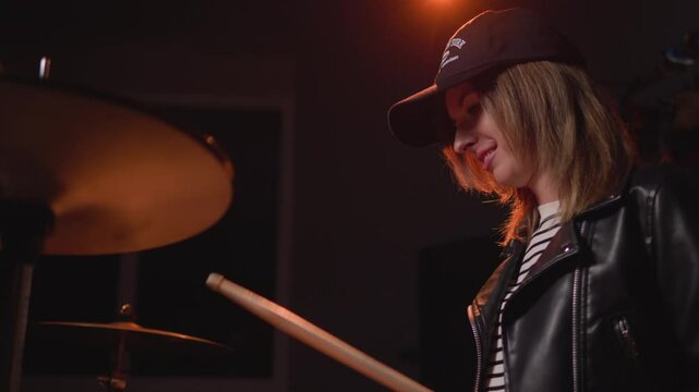 
a girl learns to play the drums