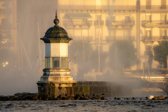 Misty morning at the lighthouse with urban backdrop