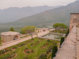 SRINAGAR KASHMIR - CIRCA - Unidentified people relax in the grounds of the Pari Mahal, a Mughal...
