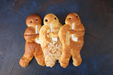 stutenkerl or weckmann. baked traditional german pastery. hefemann for st nicholas on dark background