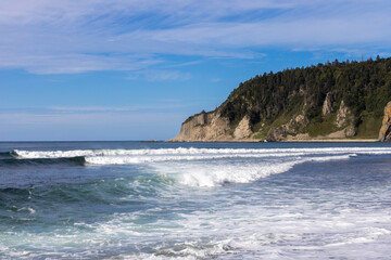 Naklejka premium Rocks of Stolbchaty. landscape with columnar basalt lavas rocks forming a natural geometric pattern. Geographic cape on the east shore of Kunashir Island of Sakhalin Oblast, Russia. Mendeleyev volcano