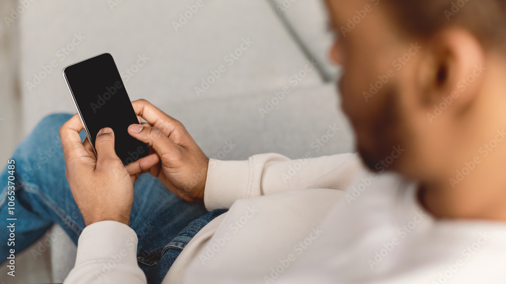 Poster people and technology concept. over the shoulder view of unrecognizable african american young man u