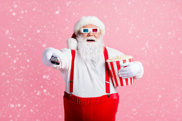 Portrait of his he nice attractive cheerful cheery bearded fat Santa watching film comedy switching...