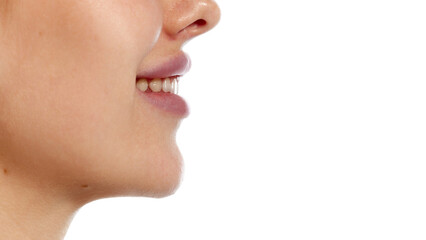 Obraz premium Side view photo of young woman with perfect smile and plump lips against white background. Lips augmentation. Concept of beauty, healthcare, freshness and wellness, confidence. Ad