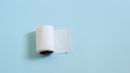 Top view of toilet paper roll on blue background