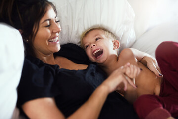 Happy, laughing and mom with child on bed for bonding, love and fun relationship in morning....