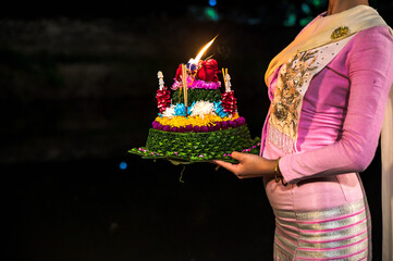 Woman holding handmade Kratong made by banana leaves for celebrate Loi Kratong festival most...