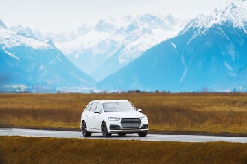 Modern SUV truck driving through lush forest landscape