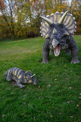 Baby triceratops plastic outdoors on lawn and female.  © lapis2380