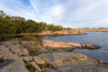 Rocky seashore and islands. Gentle smooth cliffs descend to the sea. Photo