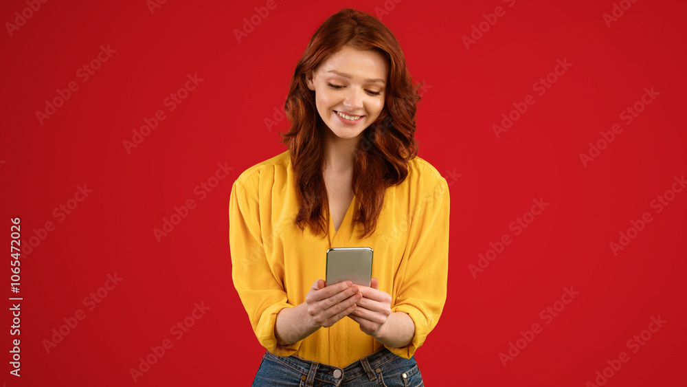 Poster millennial girl with mobile phone using application playing online game standing over green backgrou