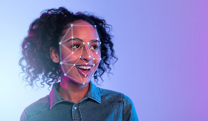 African American woman with curly hair is smiling as light patterns for facial recognition overlay...