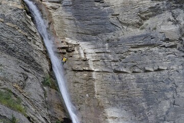 man practicing canyoning at the waterfall of el sorrosal