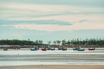 Traditional fishing boat moored on the beach in tropical sea