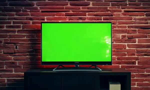 Modern tv with green screen on Red brick wall background