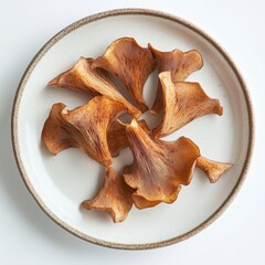 Wood ear mushrooms elegantly laid out on a white plate, with a focus on their intricate shapes