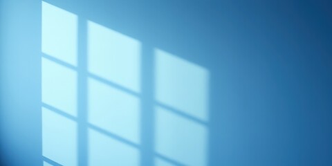 Fototapeta premium A soft blue wall with a delicate and abstract window shadow pattern from the sun's rays