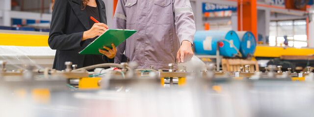 A male expertise engineering is explaining about the quality of metal sheet machine of industry to...