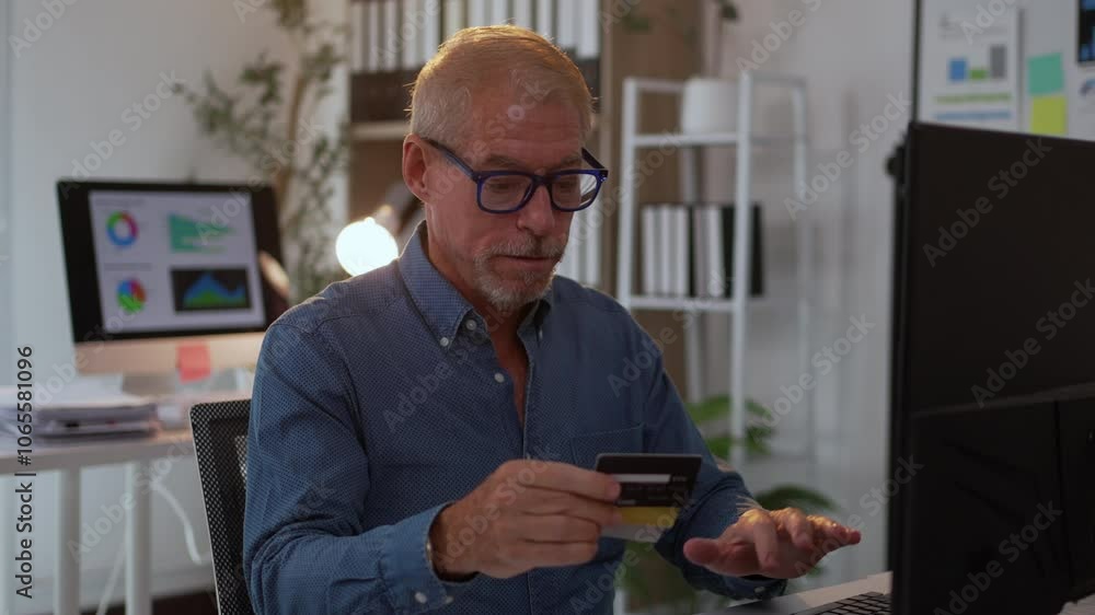 Poster businessman sitting at a desk, making an online payment with a credit card while using a laptop for 