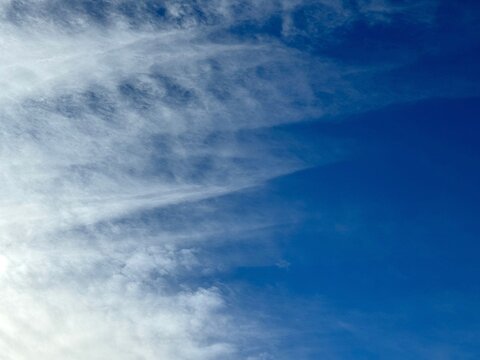 Cloudiness in the blue sky.