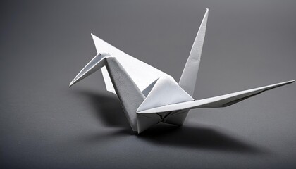 Origami crane isolated on grey background