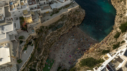 Aerial view at sunset of the Lama Monachile beach located in Polignano a Mare, in province of Bari,...