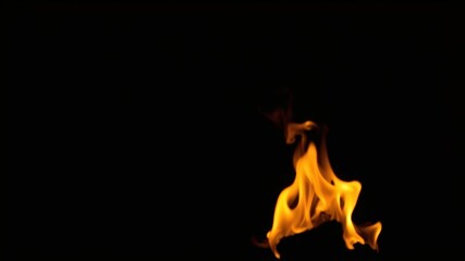 Fototapeta premium A single flame dances against a backdrop of absolute blackness, casting an ethereal glow on the otherwise empty canvas.