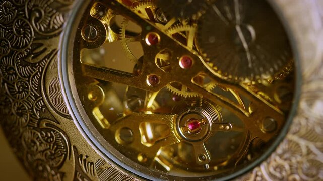 Internal golden mechanism of a vintage analog pocket watch, clockwork ticking, macro shot. Mechanics of time concept.