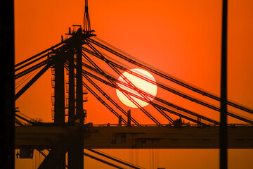 Huge crane in the harbor and sunset