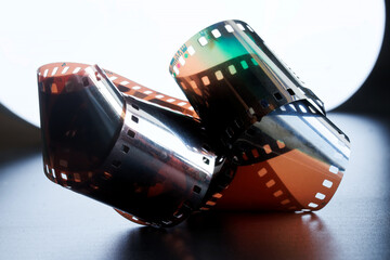 Vintage color analog film on dark background in backlight. Photo lab. Retro. Photo. Copy space