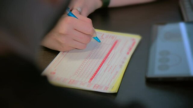 Filling out the log book card for a semi truck driver. Close up footage