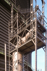 Fototapeta premium Industrial pipes and metal structures reaching for the sky at a processing plant