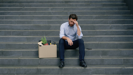 Business failure dismissed office leave sitting stairs Caucasian sad stressed businessman employer middle-aged man fired male guy in city working lost job dismissal box crisis unemployment problem